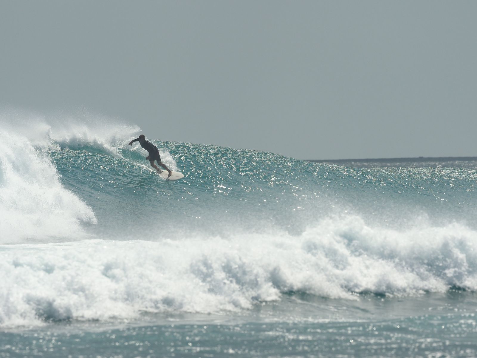 Surfer paddling at Rote Island